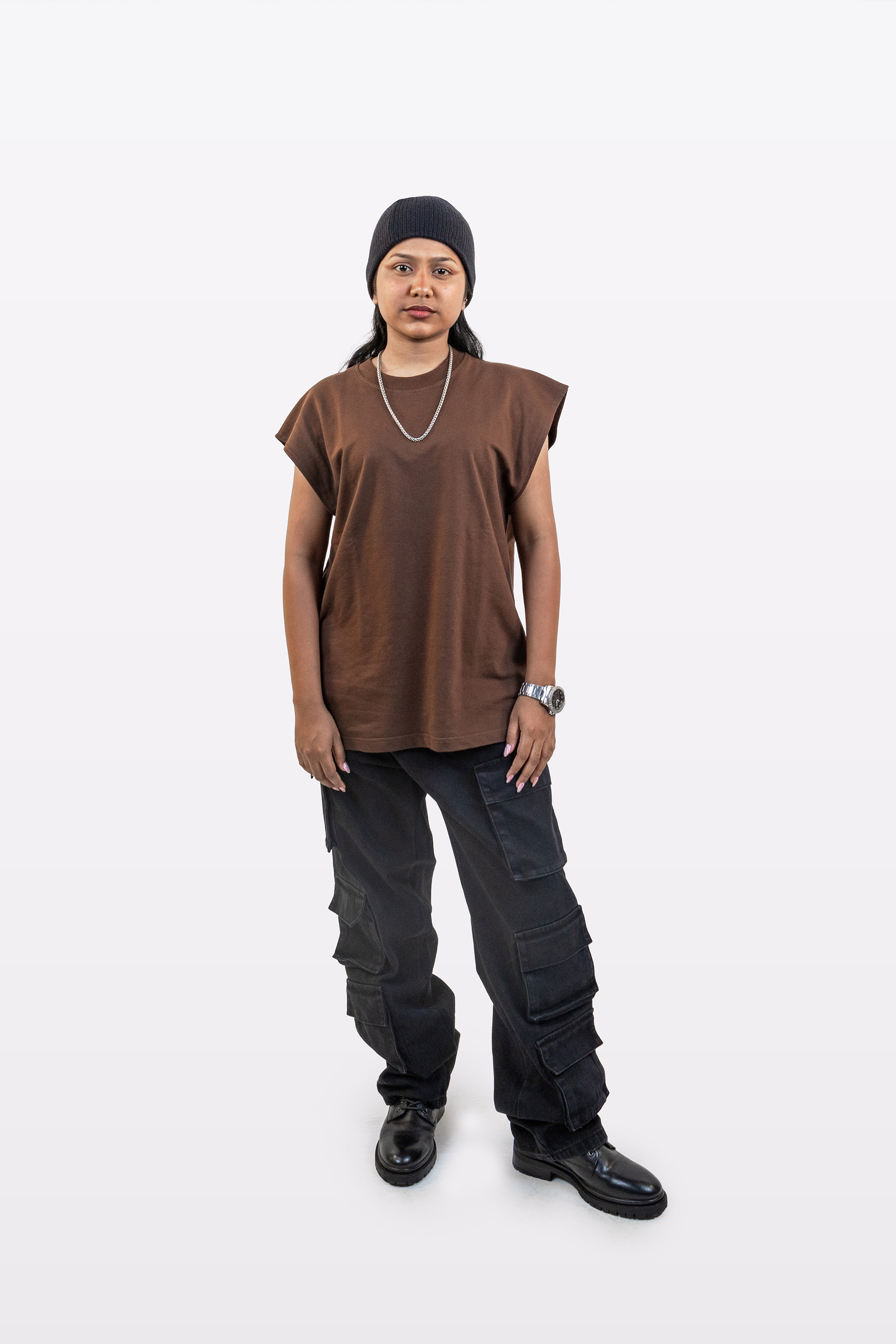 Model wearing the Harper Slein Foundation Tank in Cacao, styled with black cargo pants and accessories, against a white background.