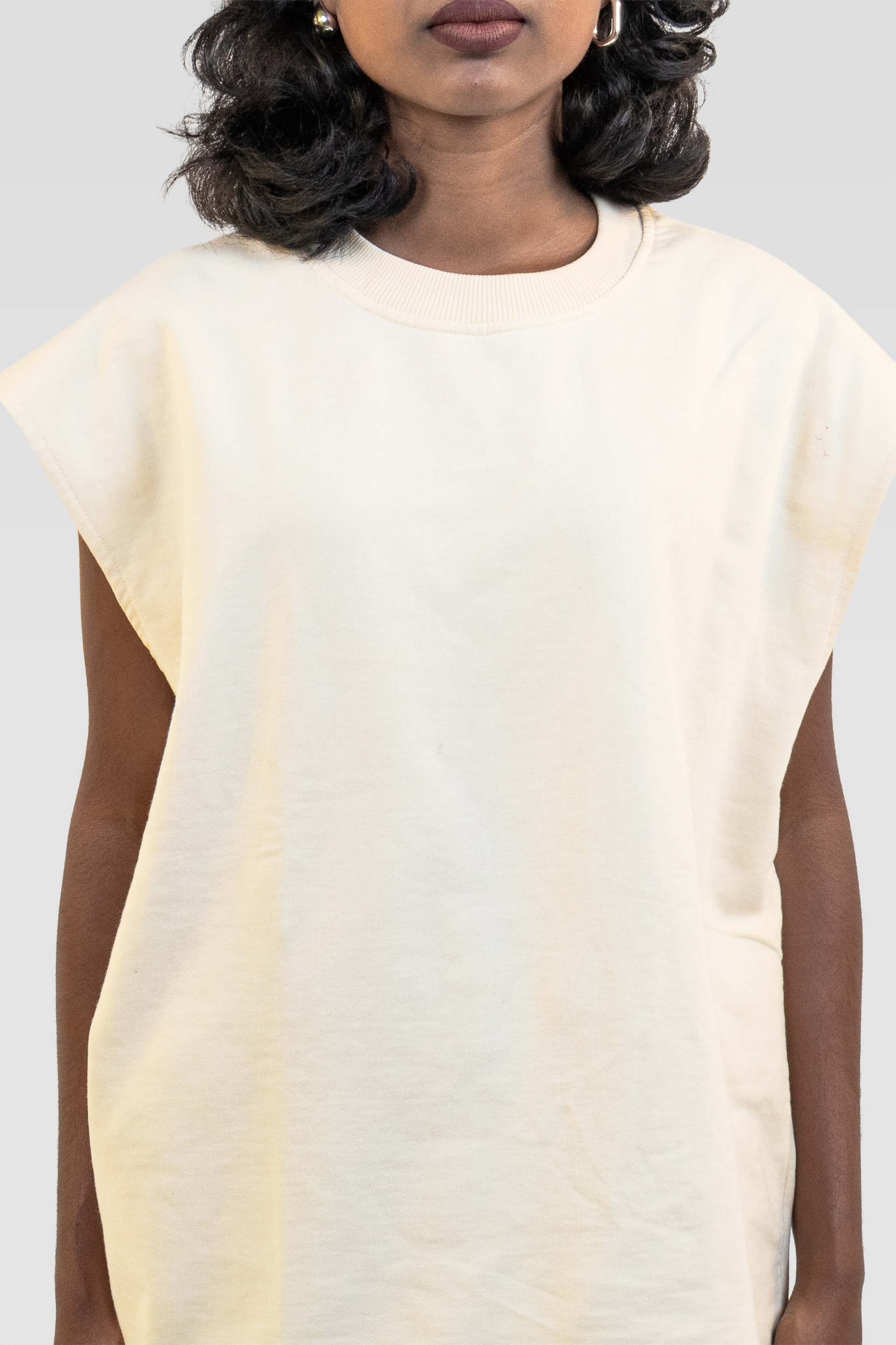 Front view of a model wearing the Harper Slein Foundation Tank in OG Off White on a white background.