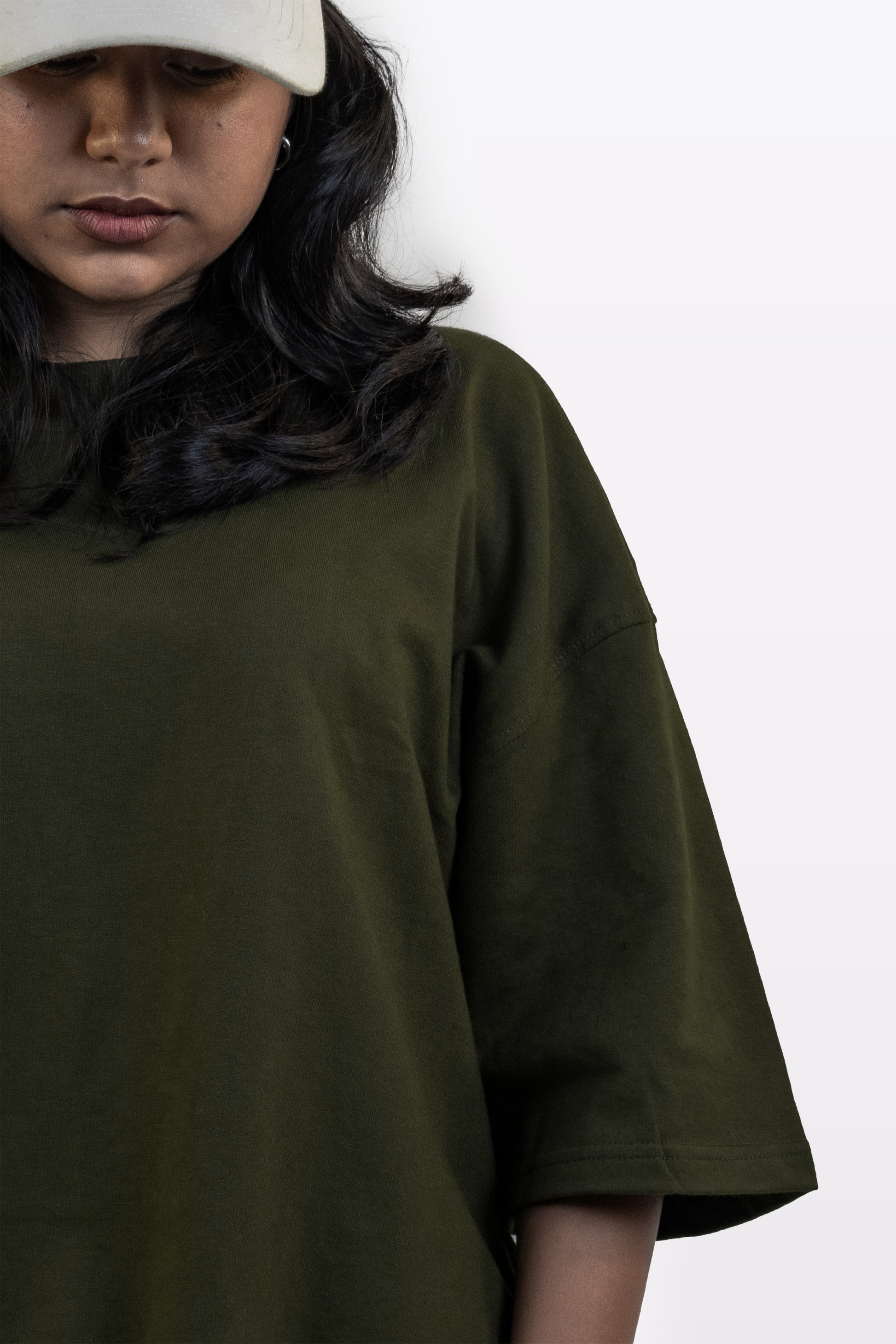 Close-up of a female model wearing the Harper Slein oversized t-shirt in Nori Seaweed Green, featuring a relaxed fit, soft drape, and premium 240 GSM cotton fabric.
