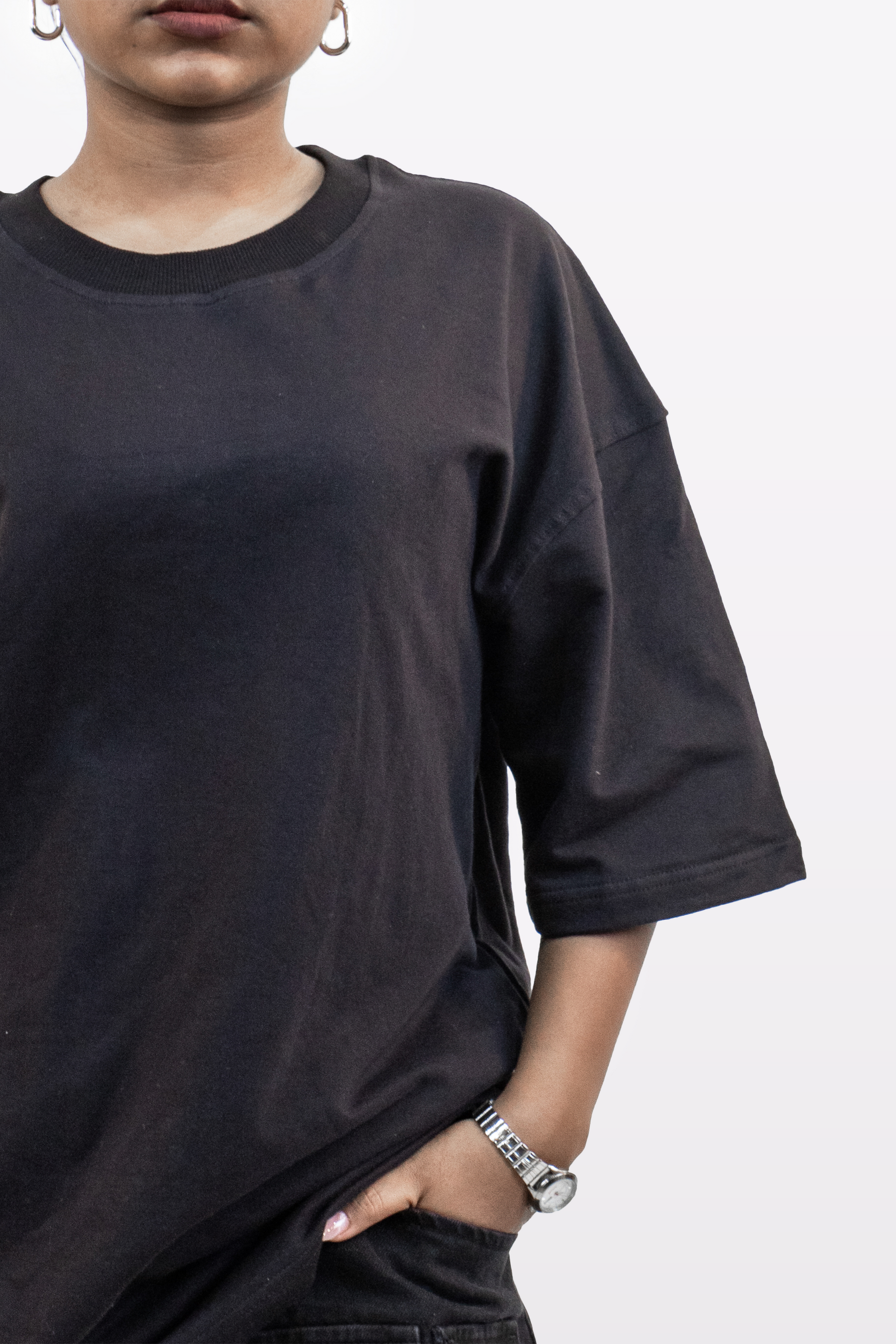 Close-up front view of female model wearing Harper Slein oversized t-shirt in Classic Black, showing neckline, sleeves, and fit on a white background