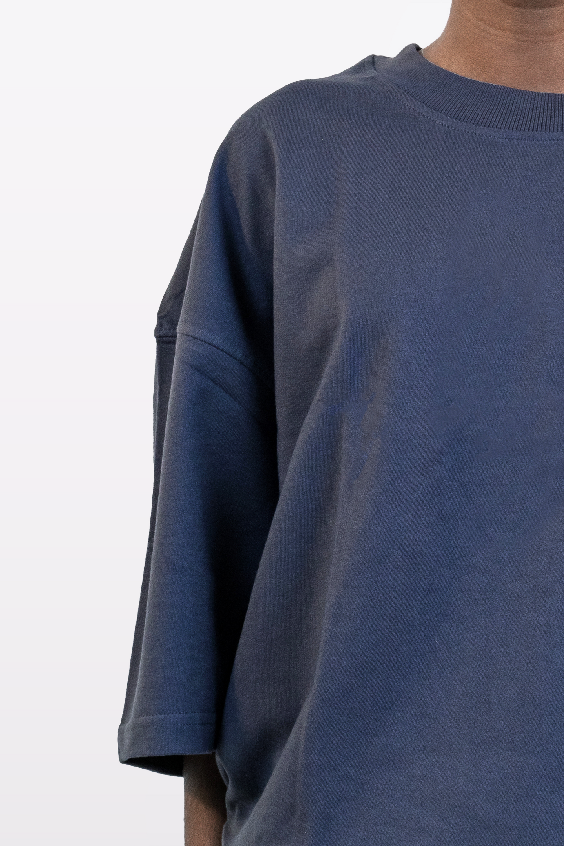 Fabric close-up of Harper Slein oversized t-shirt in Compass Blue, showing texture and stitching details, on a white background