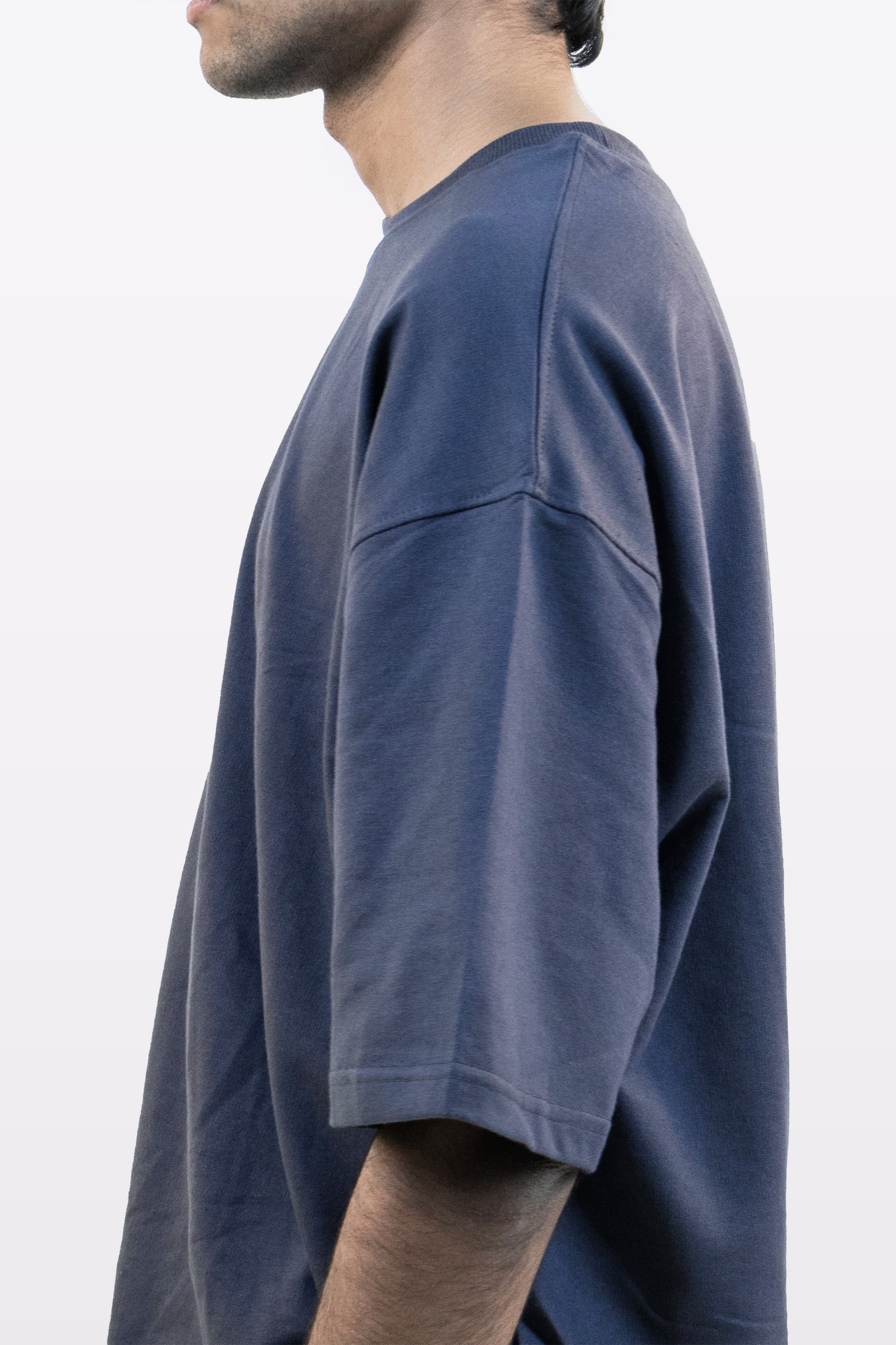 Close-up side detail of Harper Slein oversized t-shirt in Compass Blue, showing sleeve and shoulder seam, on a white background