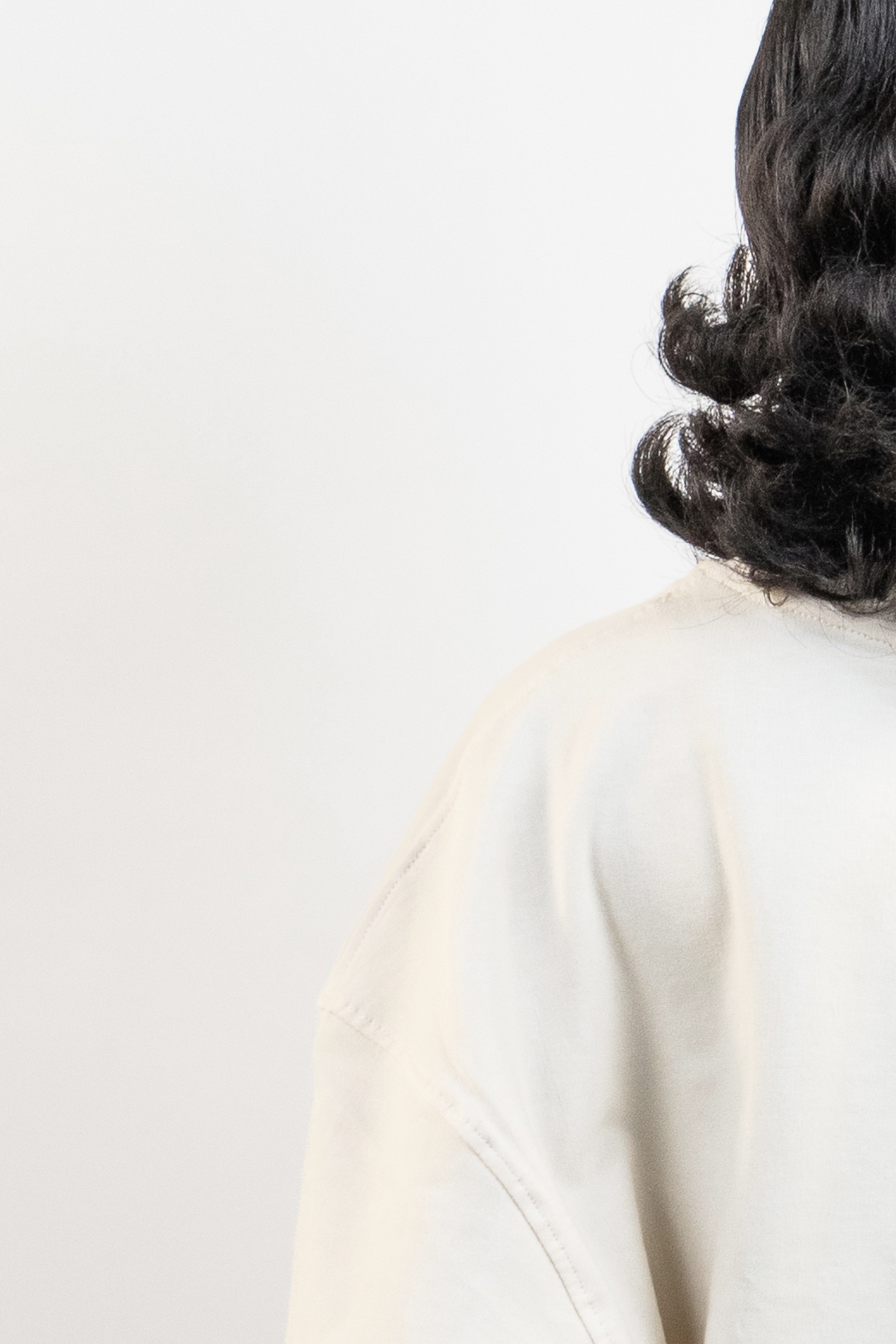 Close-up of Harper Slein oversized t-shirt in OG Off White showing shoulder seam and fabric texture on a plain white background