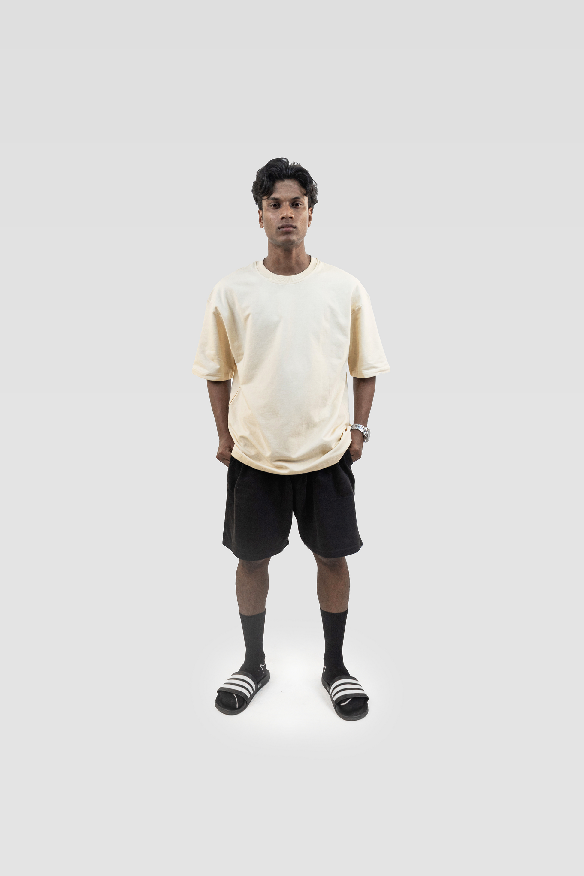 Front view of model wearing Harper Slein oversized t-shirt in OG Off White with black shorts on a white background