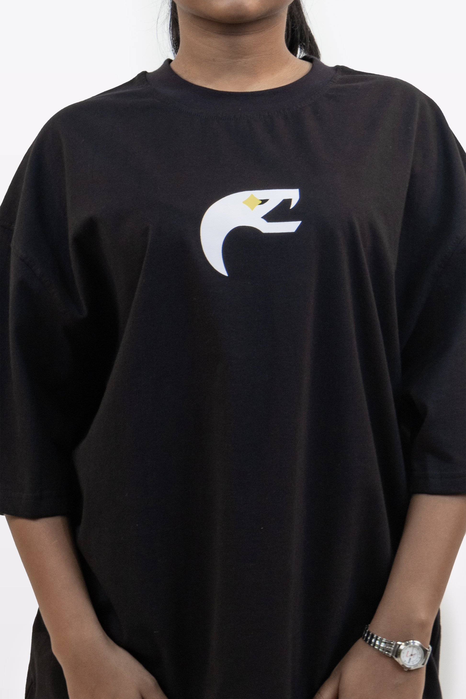 Close-up front view of the Harper Slein Urban Crew Collection black T-shirt, featuring the white and yellow stylized snake logo on the chest.