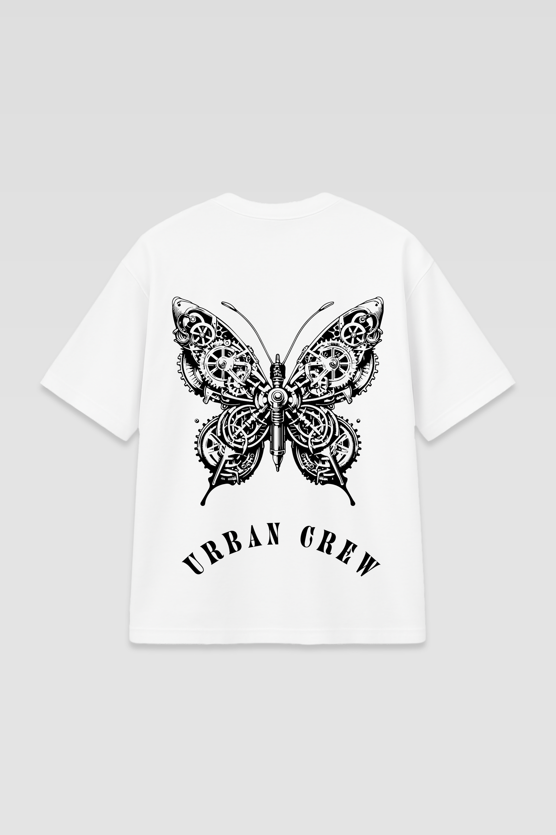 Flat lay of the Harper Slein Urban Crew Collection T-Shirt in white, featuring an intricate black butterfly design with mechanical detailing and ‘Urban Crew’ text on the back, displayed against a light gray background.