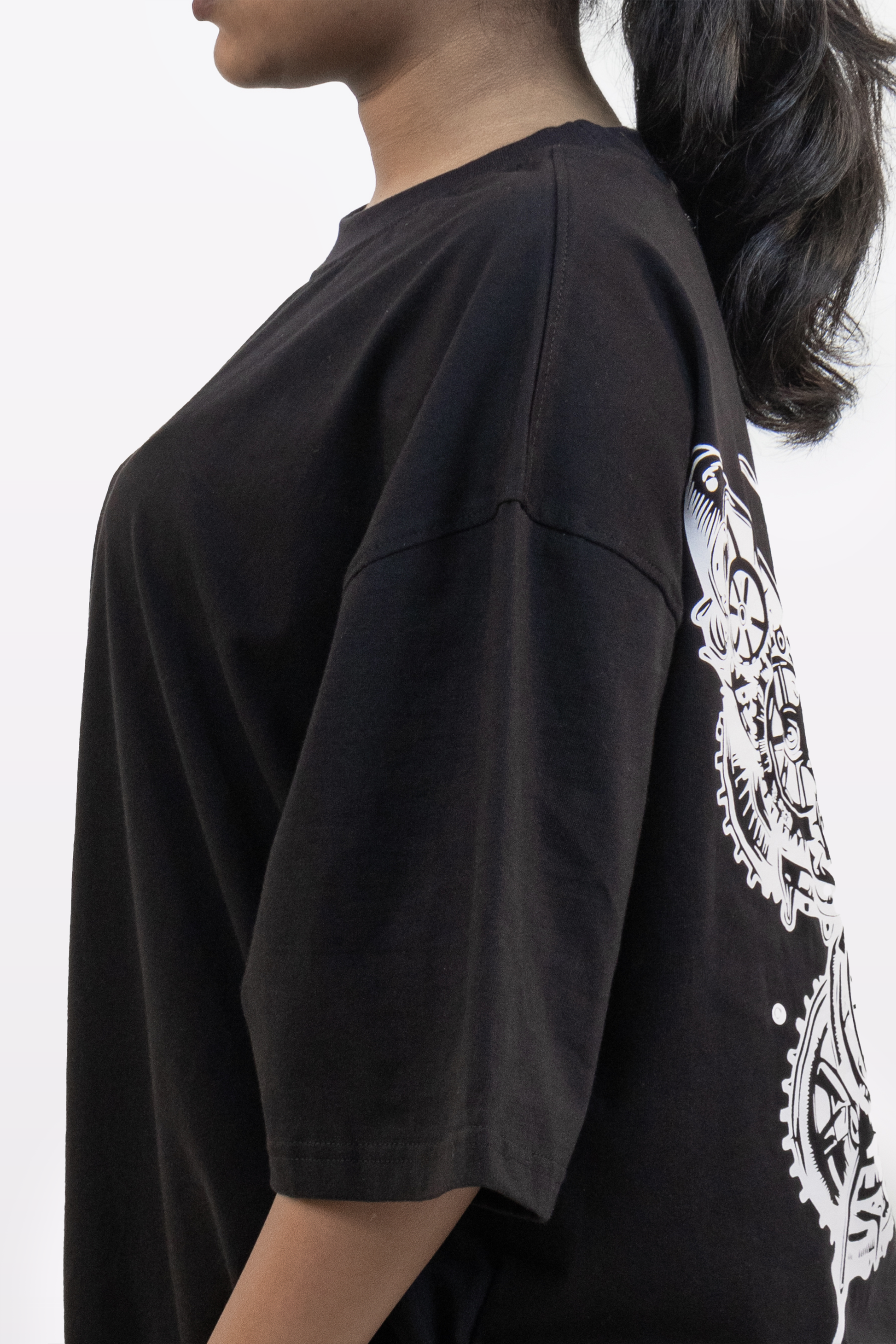 Close-up side view of the Harper Slein Urban Crew Collection T-Shirt in black, showing the oversized sleeve and part of the intricate white butterfly design on the back.