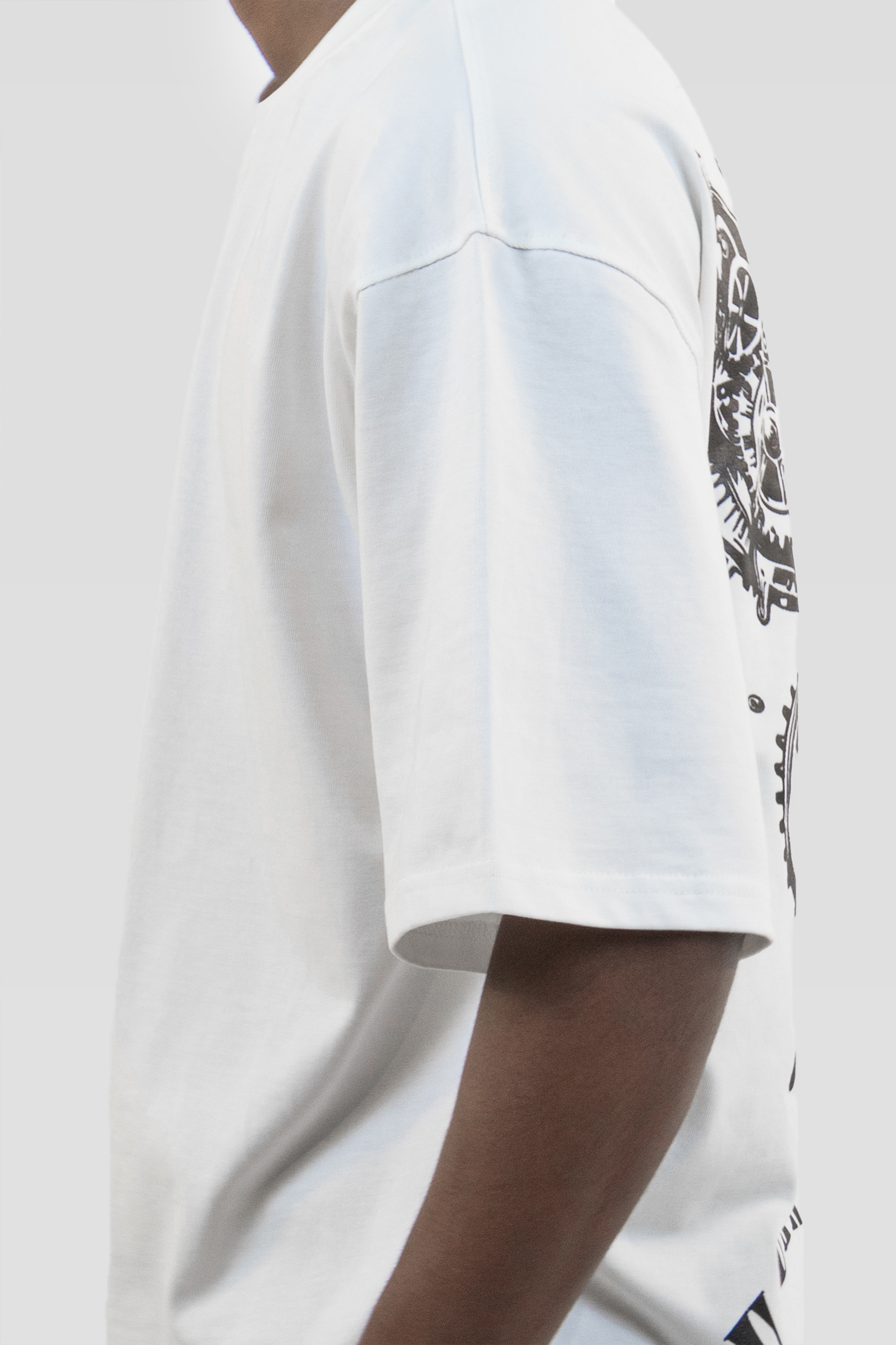 Side view detail of the Harper Slein Urban Crew Collection Butterfly T-Shirt in white, showing part of the black butterfly graphic on the back, worn by a model against a light grey background.