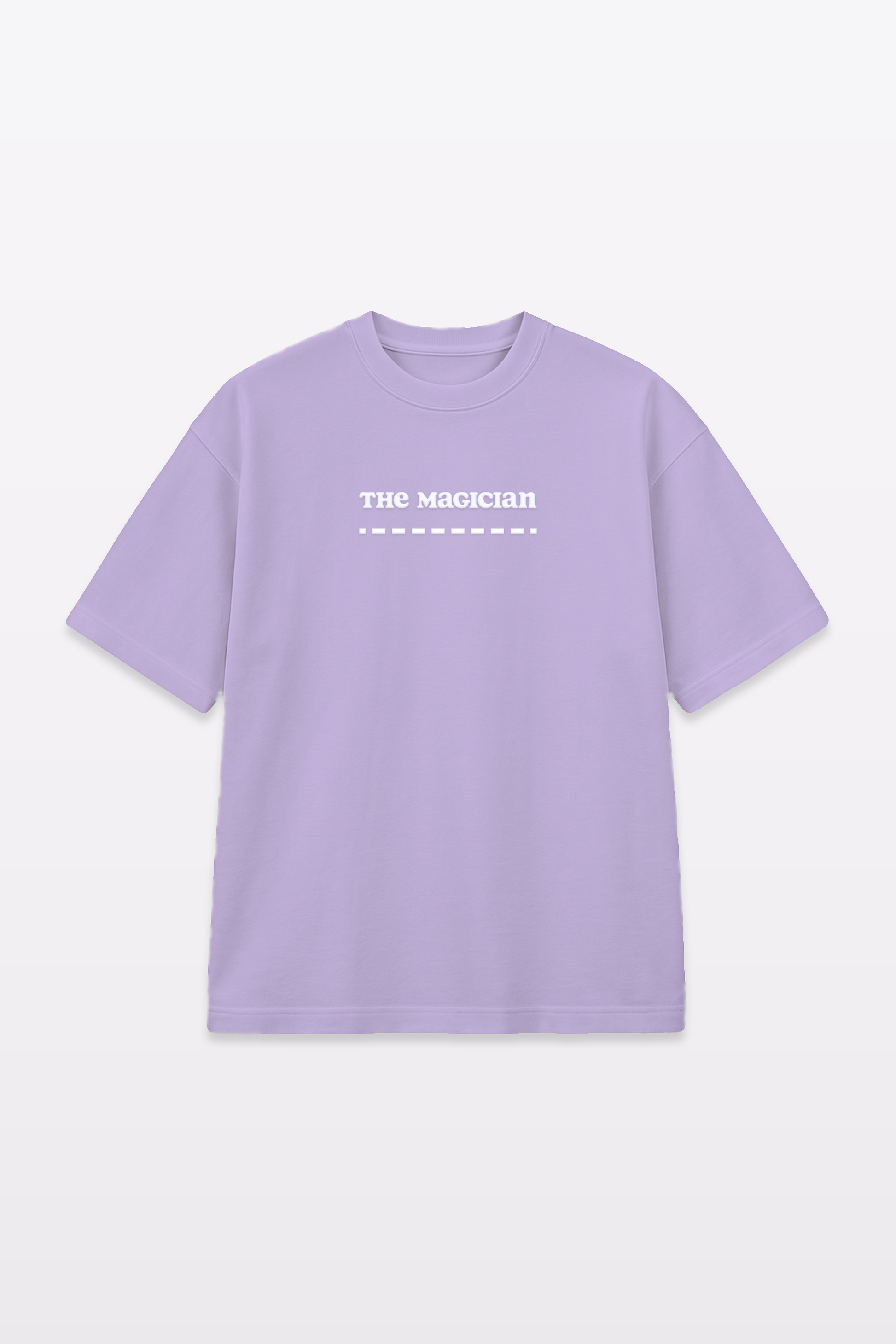 Flat lay of a lavender t-shirt with ‘The Magician’ text in white on the chest, displayed against a plain white background.