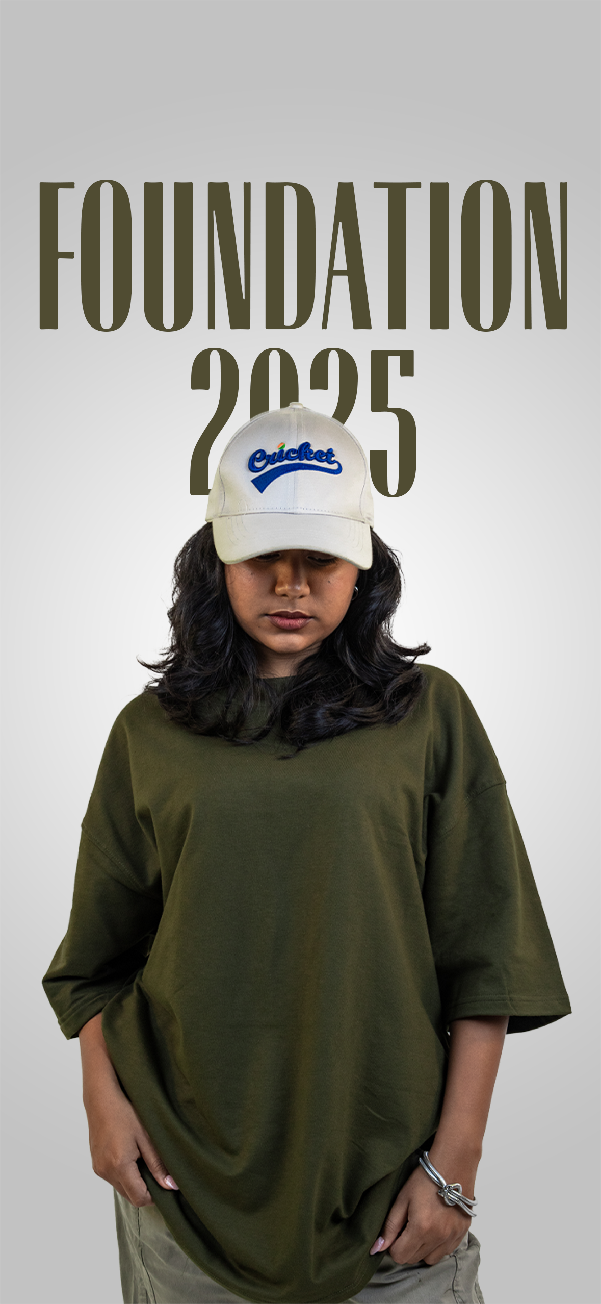 Harper Slein Foundation 2025 campaign cover featuring model in Nori Seaweed Green oversized tee, beige cap with blue logo, and light cargo pants, standing against a gradient background with ‘Foundation 2025’ text above.