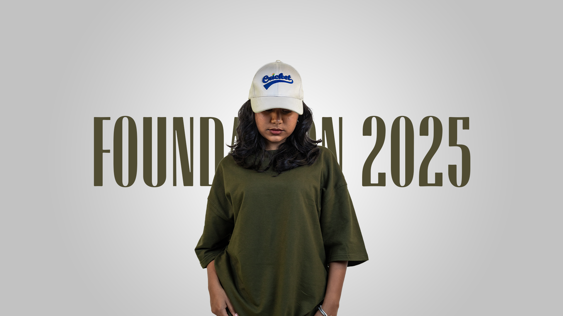 Harper Slein Foundation 2025 campaign cover featuring model in Nori Seaweed Green oversized tee, beige cap with blue logo, and light cargo pants, standing against a gradient background with ‘Foundation 2025’ text behind.