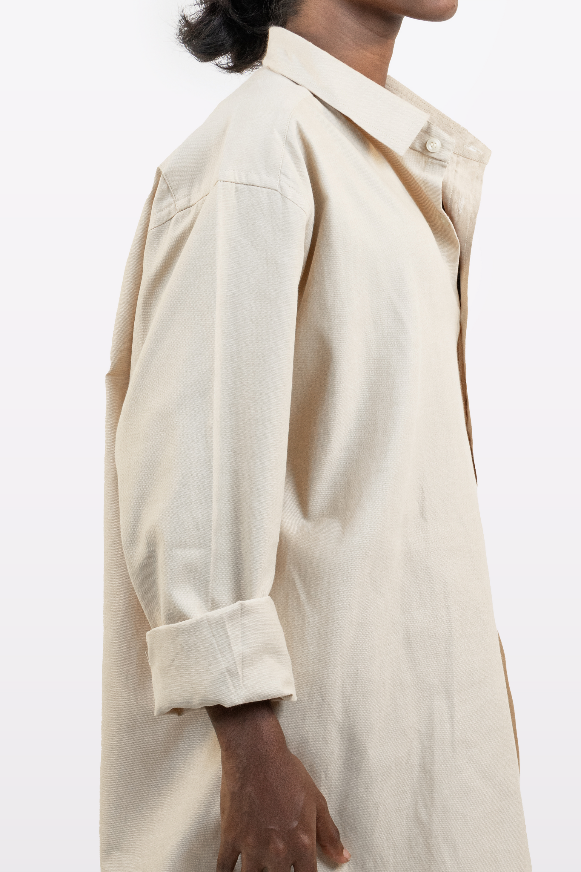 Cropped side view of a model wearing the Harper Slein Off White Oxford Shirt on a white background