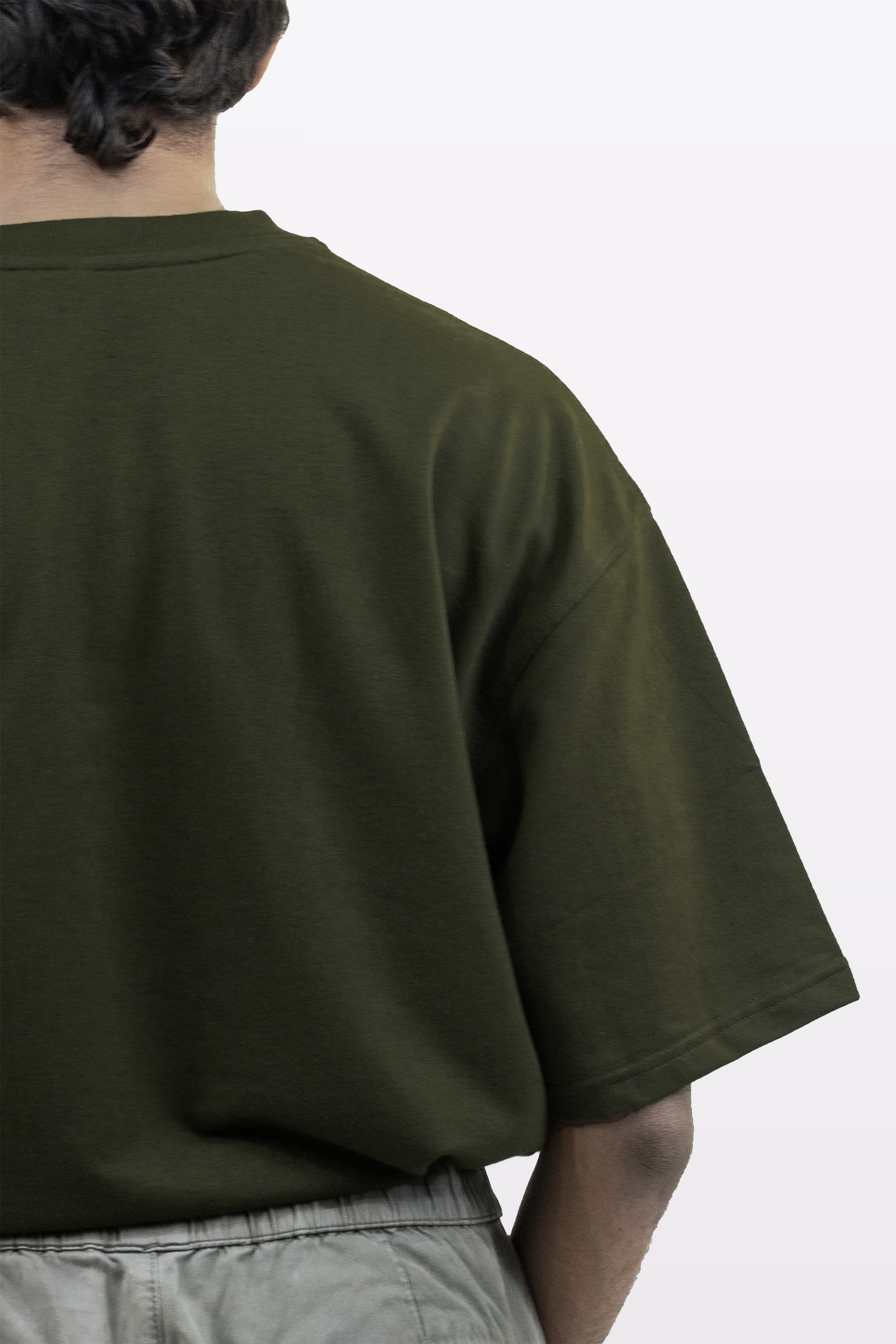 Back detail view of a model wearing the Harper Slein oversized t-shirt in Nori Seaweed Green, showing the relaxed fit and soft drape.
