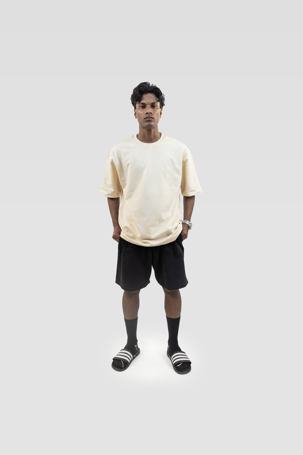 Front view of model wearing Harper Slein oversized t-shirt in OG Off White with black shorts on a white background