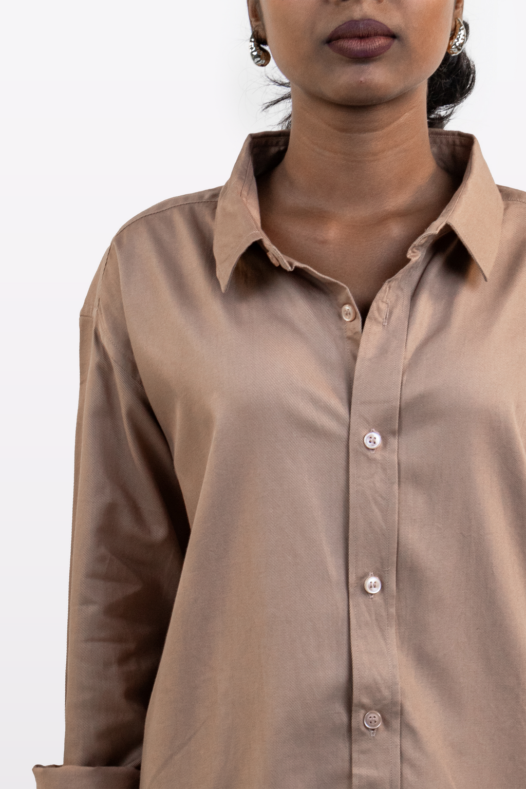 Model wearing Harper Slein brown Oxford shirt, close-up front view, on a white background.