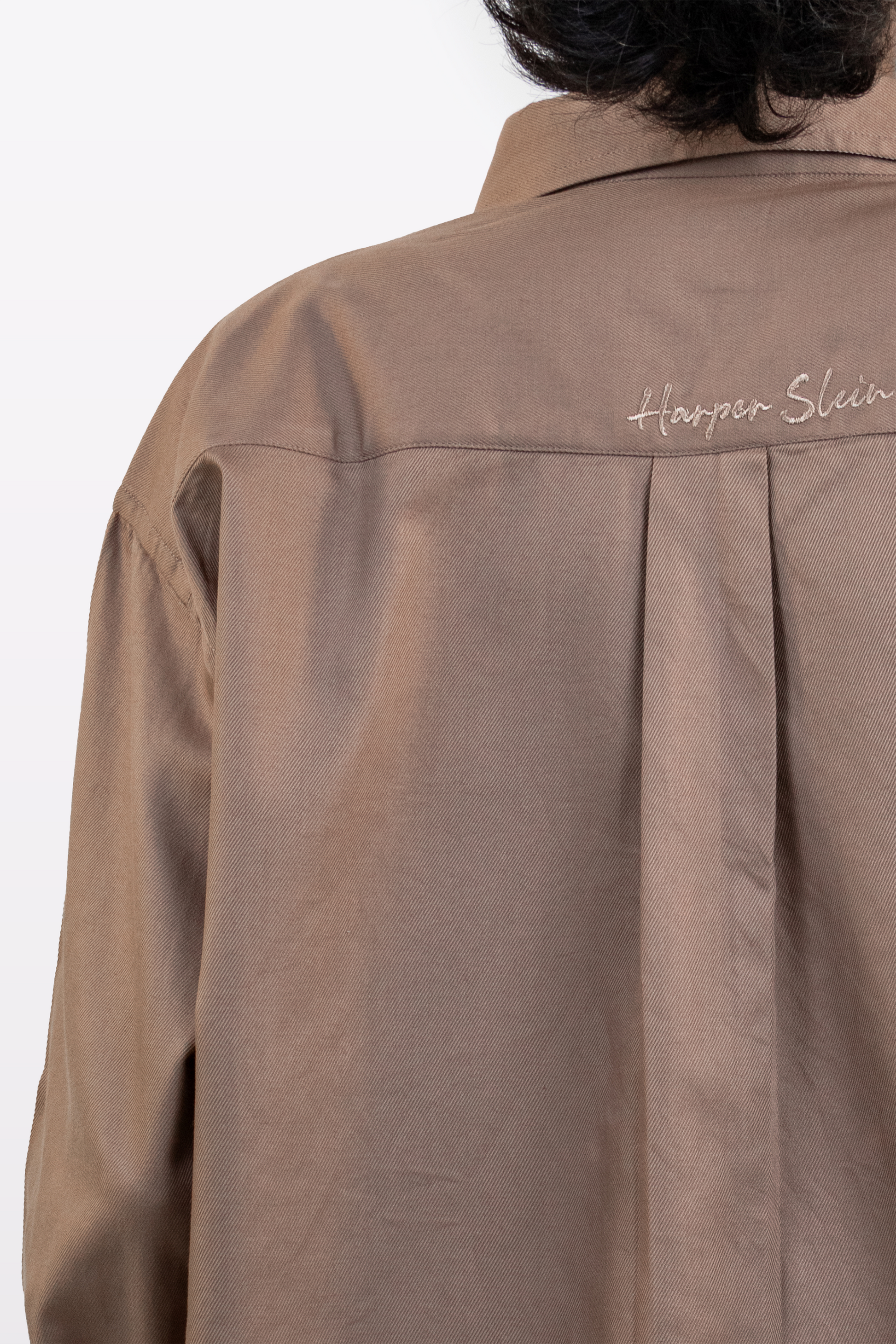 Close-up of the Harper Slein branding on the back of the Brown Oxford Shirt against a white background.