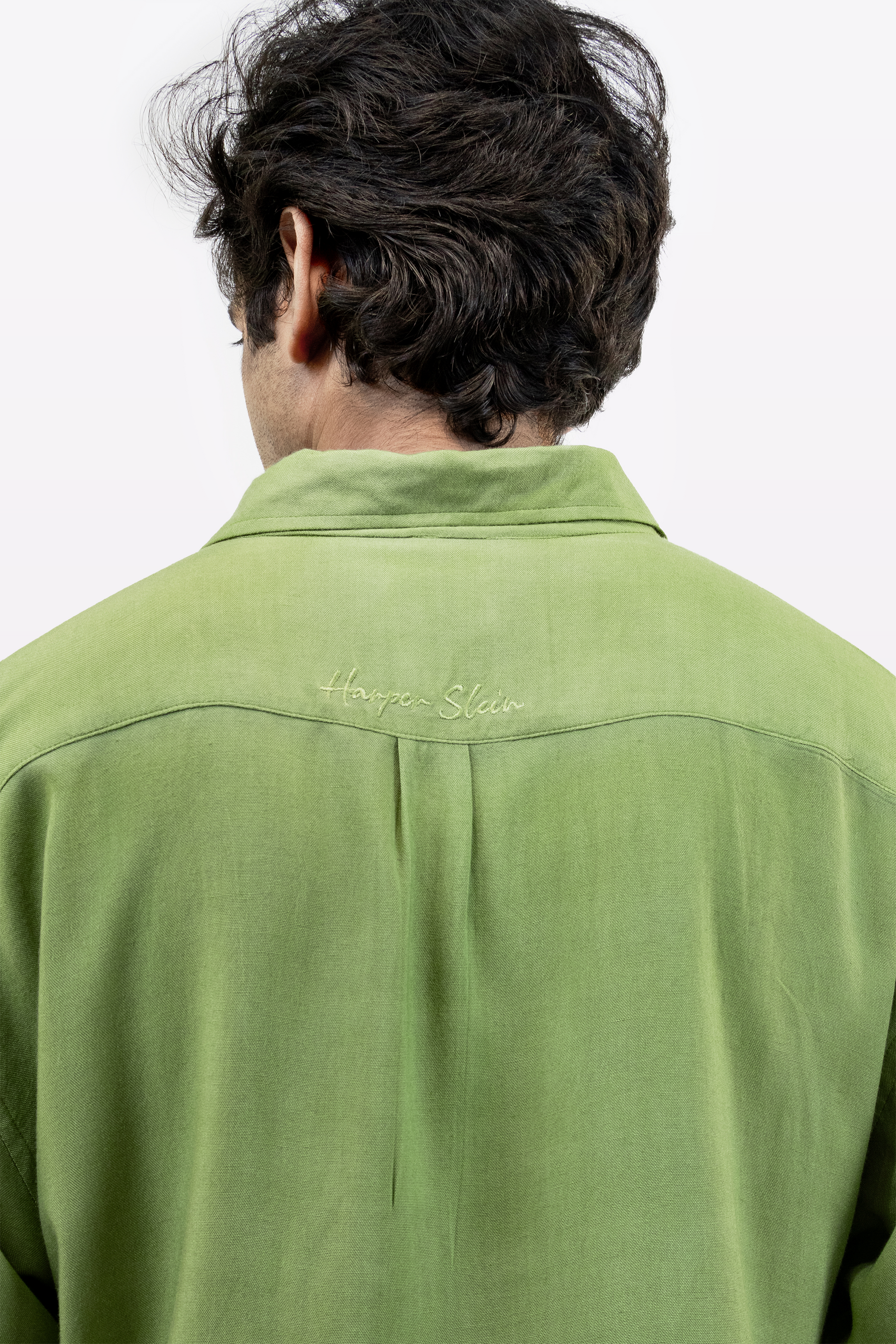 Harper Slein Moss Shirt in green, close-up back view with logo embroidery, worn by model