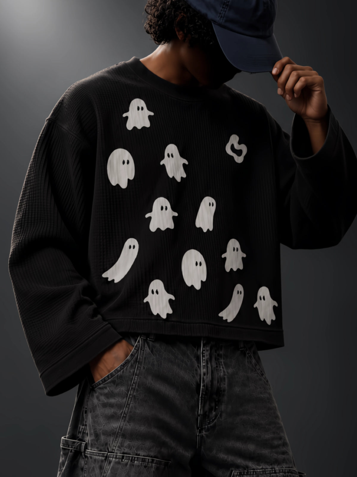 Close-up of the white ghost graphics, crew neck and waffle-knit texture of the Afterlife tee