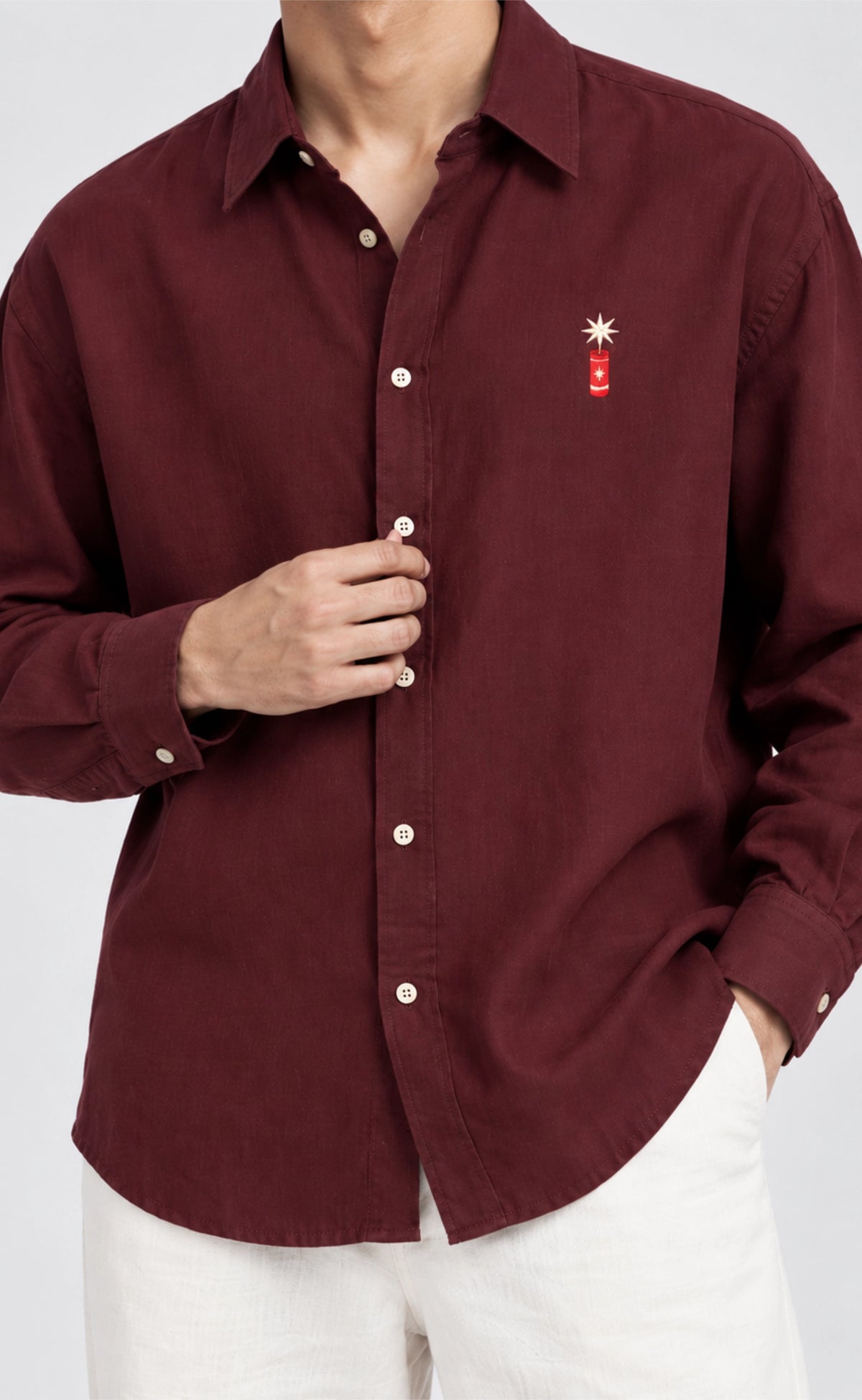 Front detail of the burgundy cotton firecracker shirt with button closure and long sleeves