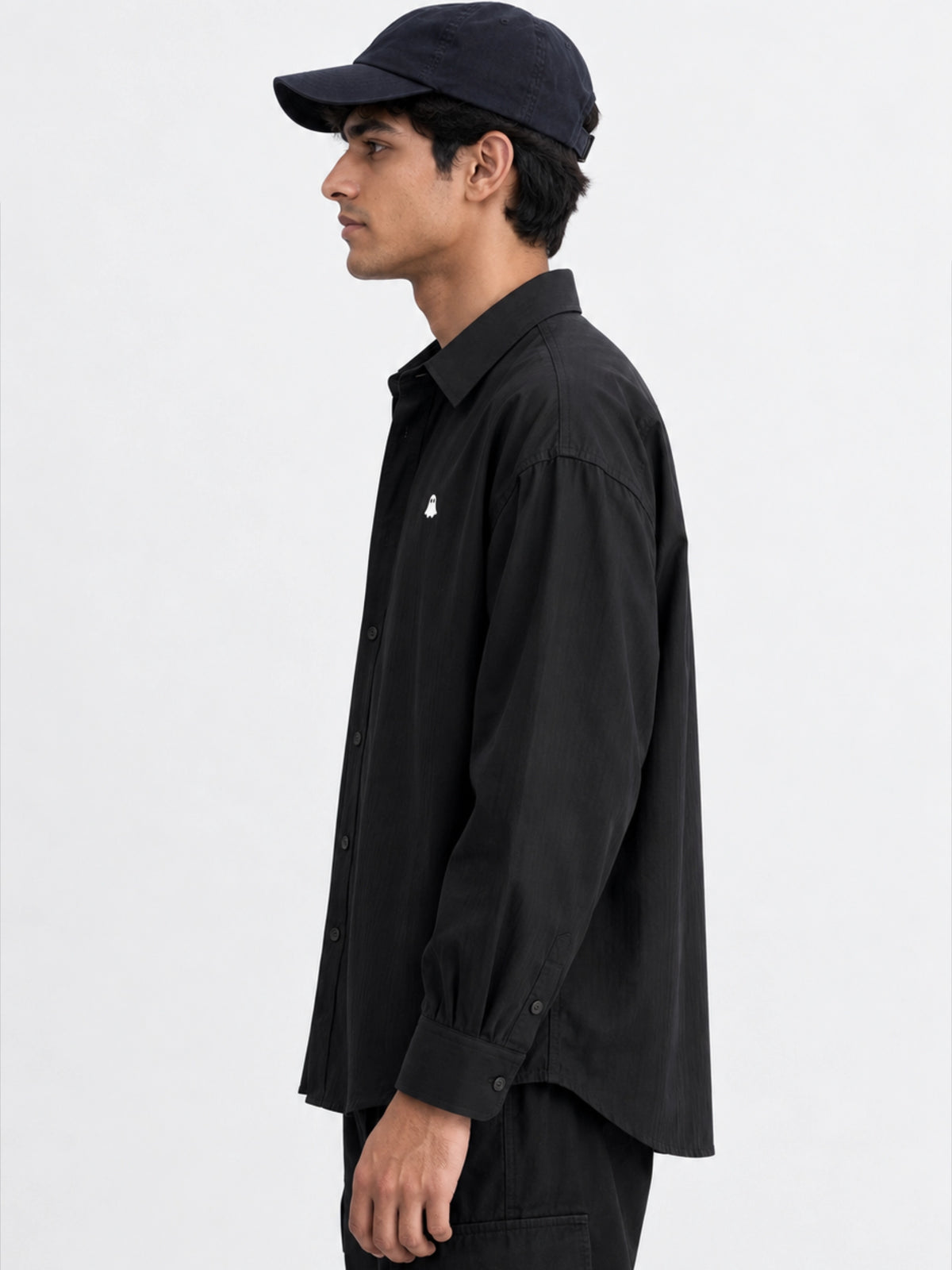 Side view of The Ghost Shirt with long sleeves and curved hem
