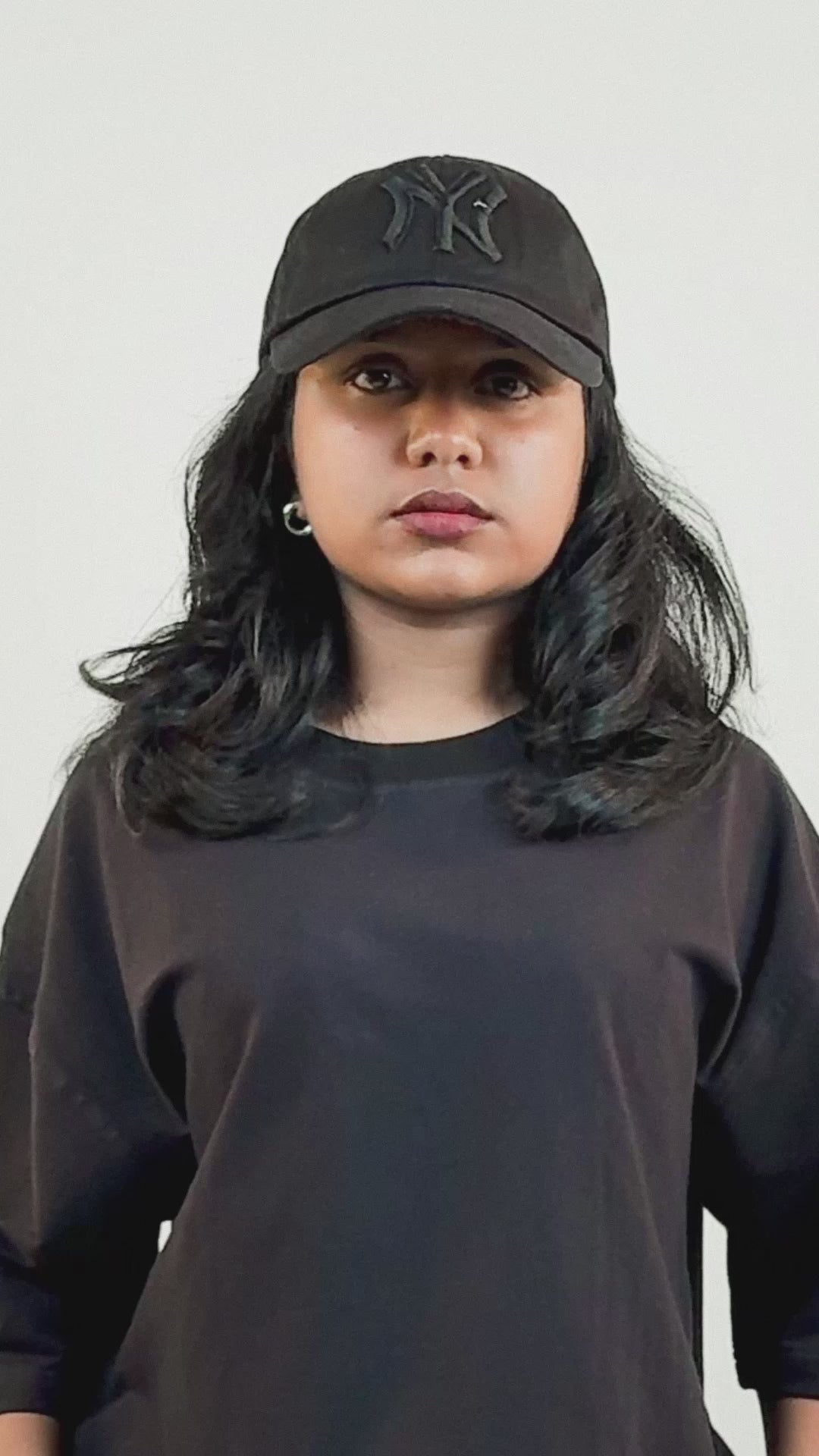 Harper Slein black oversized Foundation Tee made from premium 240 GSM cotton, worn by model with a black cap and minimal accessories, showcasing its clean and versatile design.