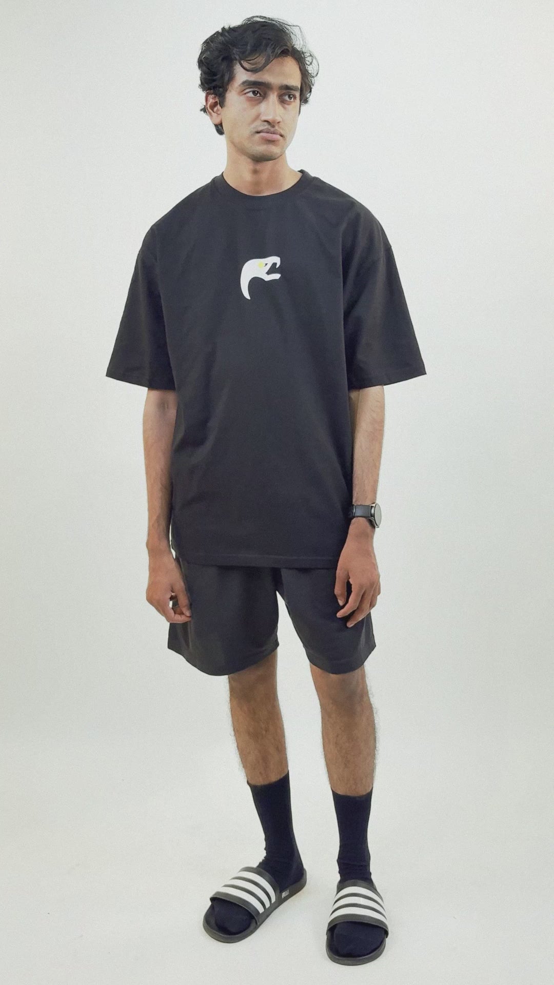 Harper Slein Urban Crew black oversized tee in premium cotton, featuring a small front logo and large intricate white butterfly gear graphic on the back, shown on male and female models styled with shorts and casual footwear, highlighting its bold streetwear aesthetic.